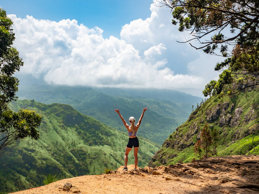 Trekker standing at a scenic mountain ridge viewpoint in Ella, Sri Lanka
