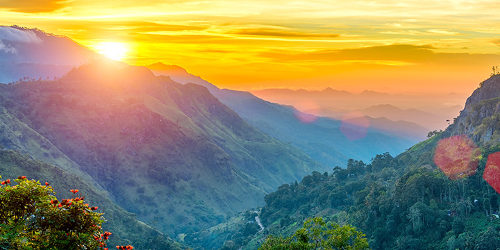 Vibrant golden sunrise breaking across the mountain valley of Ella Gap